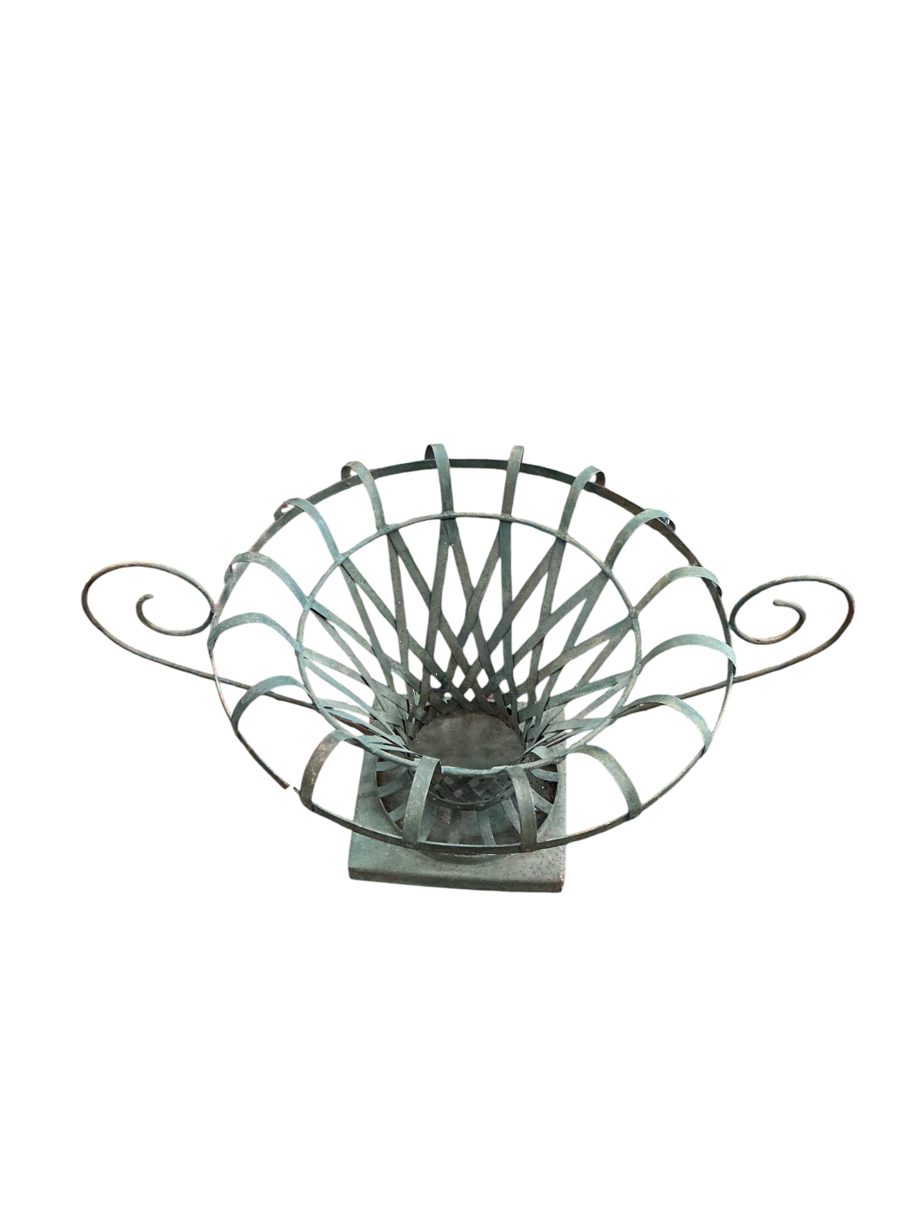 A pair of large painted wrought iron strapwork flower urns, diameter 90cm, height 44cm